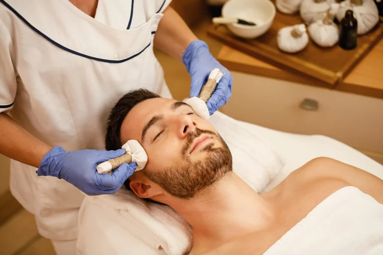 relaxed-man-having-thai-herbal-head-massage-wellness-center-scaled