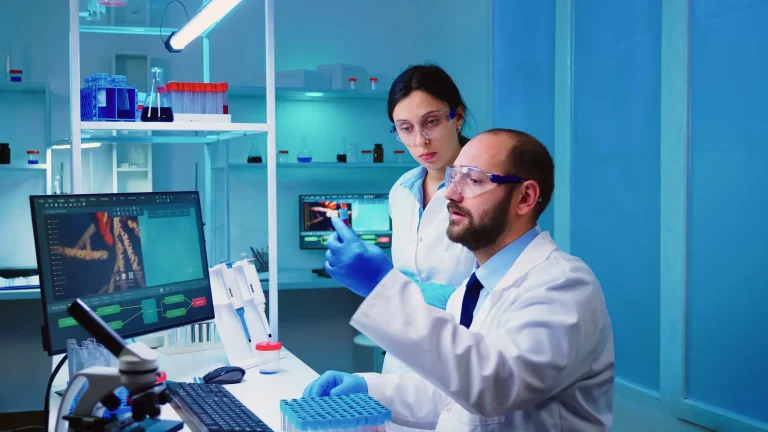 chemist-doctor-explaining-nurse-vaccine-development-modern-equipped-laboratory-holding-test-tube-with-blood-sample-scaled