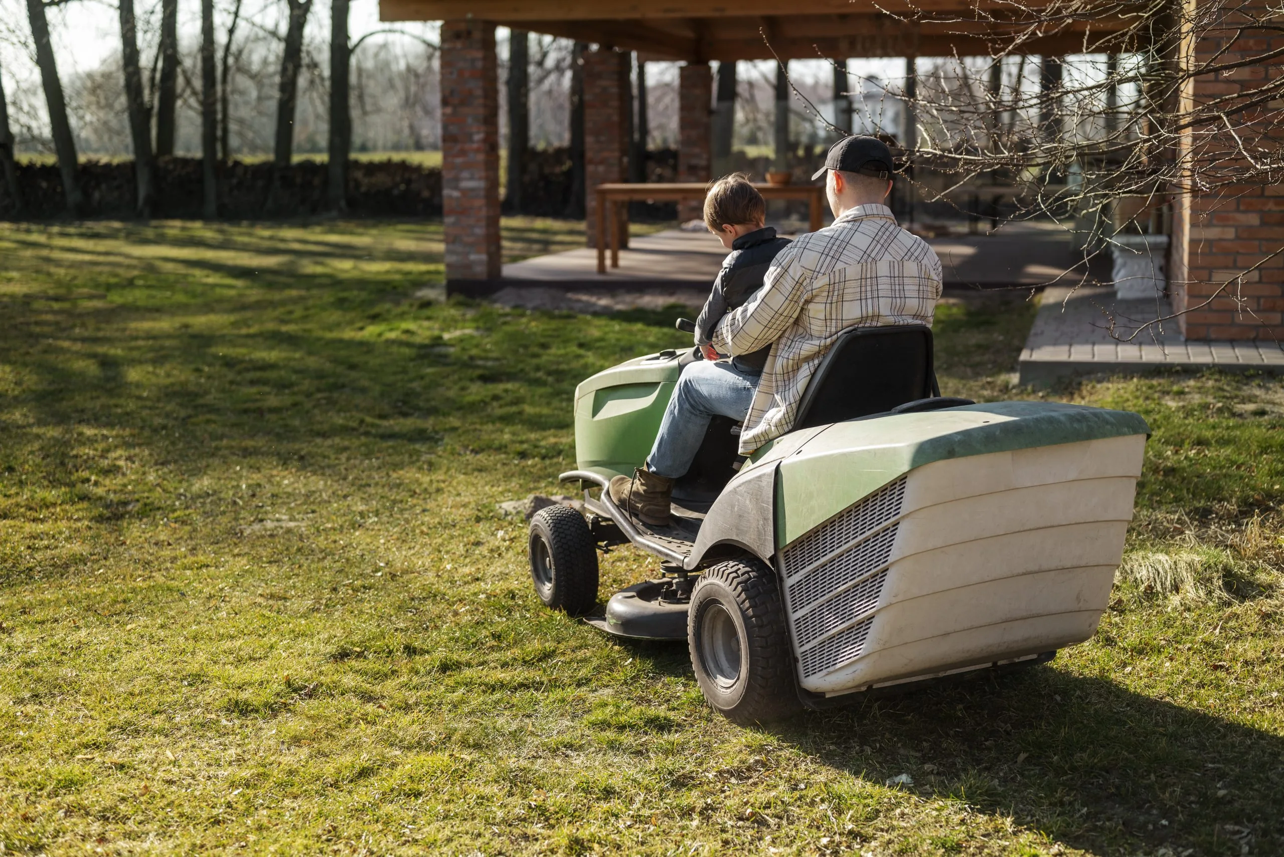 full-shot-man-driving-lawn-mower-scaled